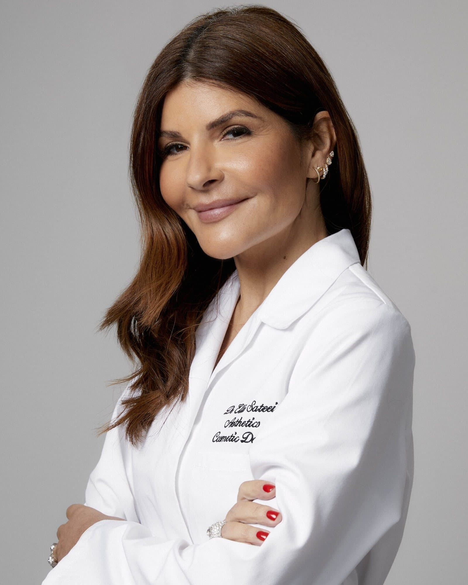 Dr Ellie Sateei in a white clinical coat